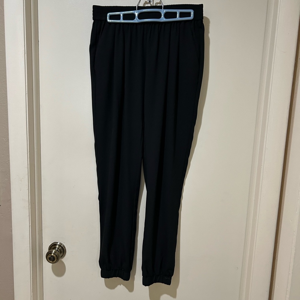 Black ankle length haram pants with side pockets, elastic waist.